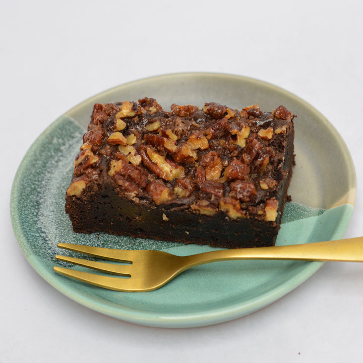 Maple Pecan Brownie on small plate with gold fork