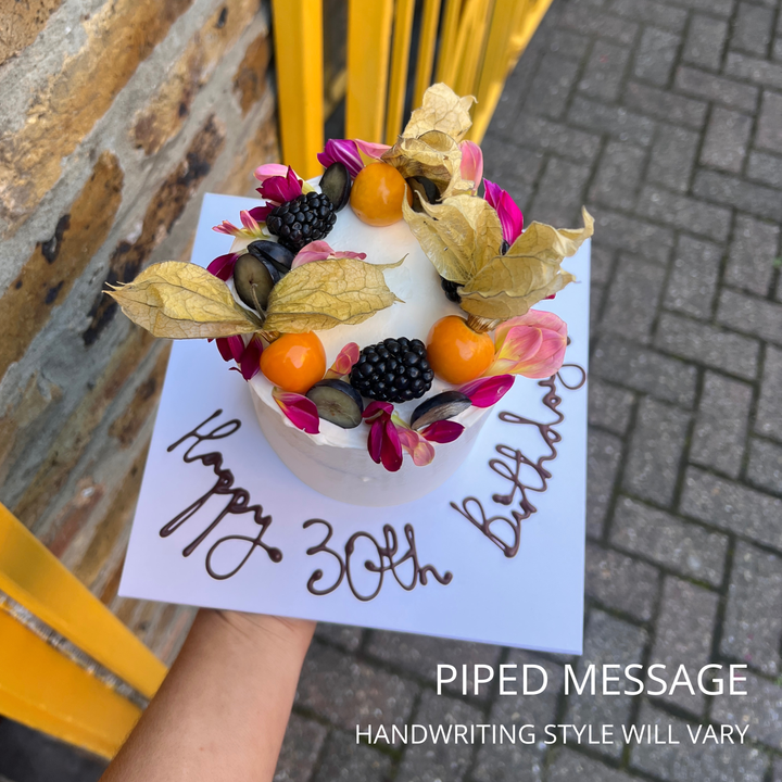 Birthday cake with piped '30th Birthday' message, physalis and blackberries