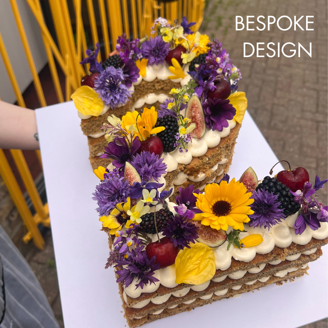 2nd Birthday Cake. Naked-style cake with purple flowers and fruit and yellow flowers. London