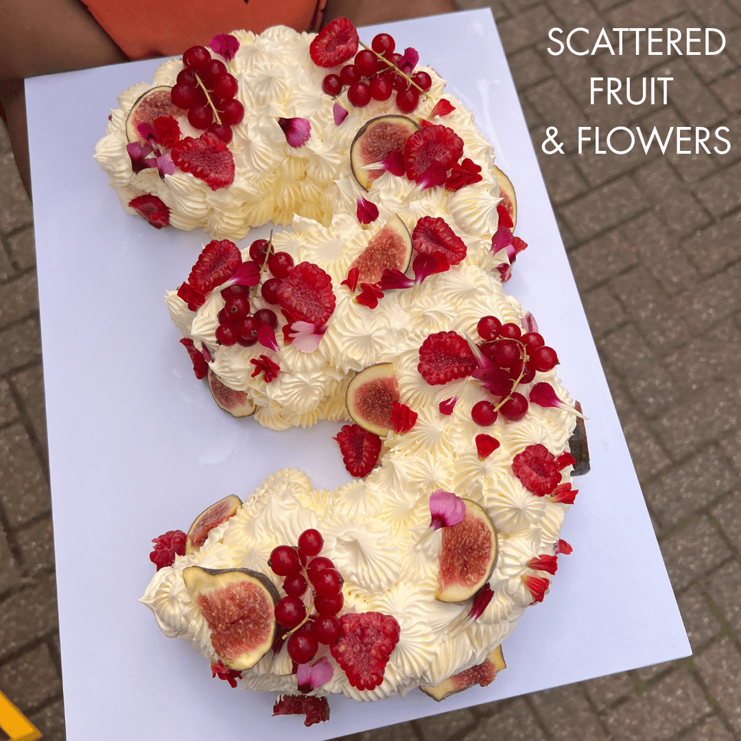 Number 3 cake decorated with raspberries, figs, redcurrants and edible flowers. London
