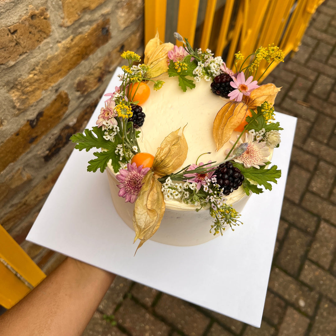 Italian lemon birthday cake decorated with physalis, blackberries and edible flowers, London