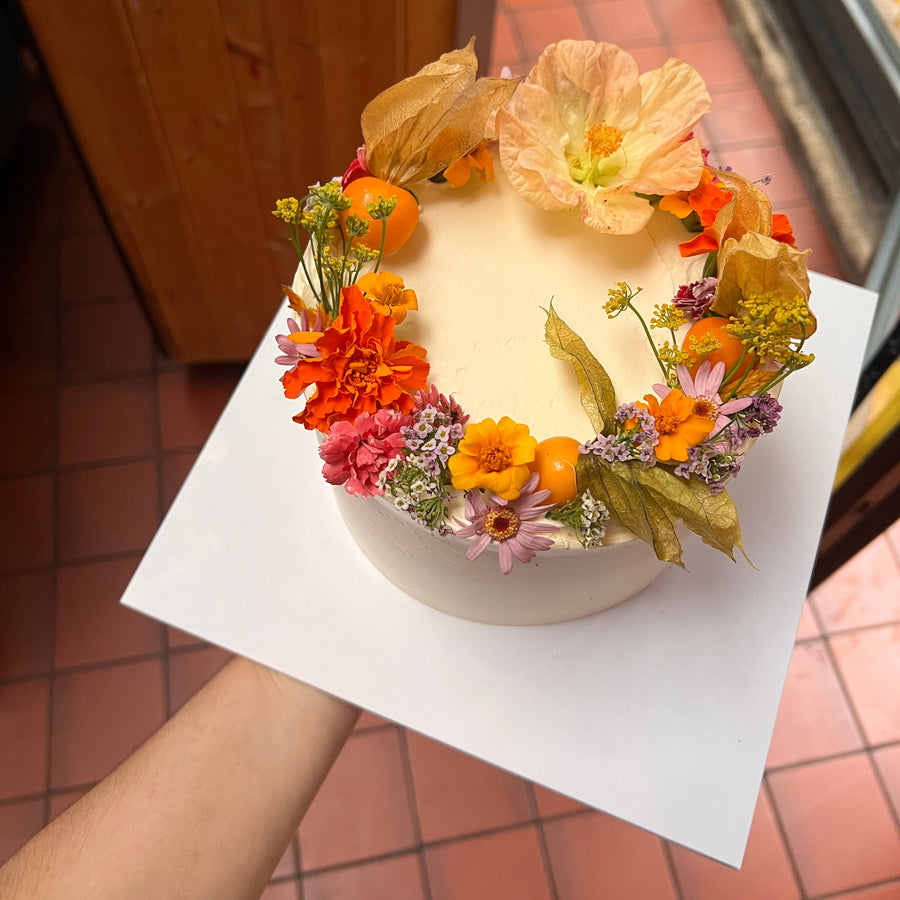 Sunshine cake decorated with physalis and edible flowers, London